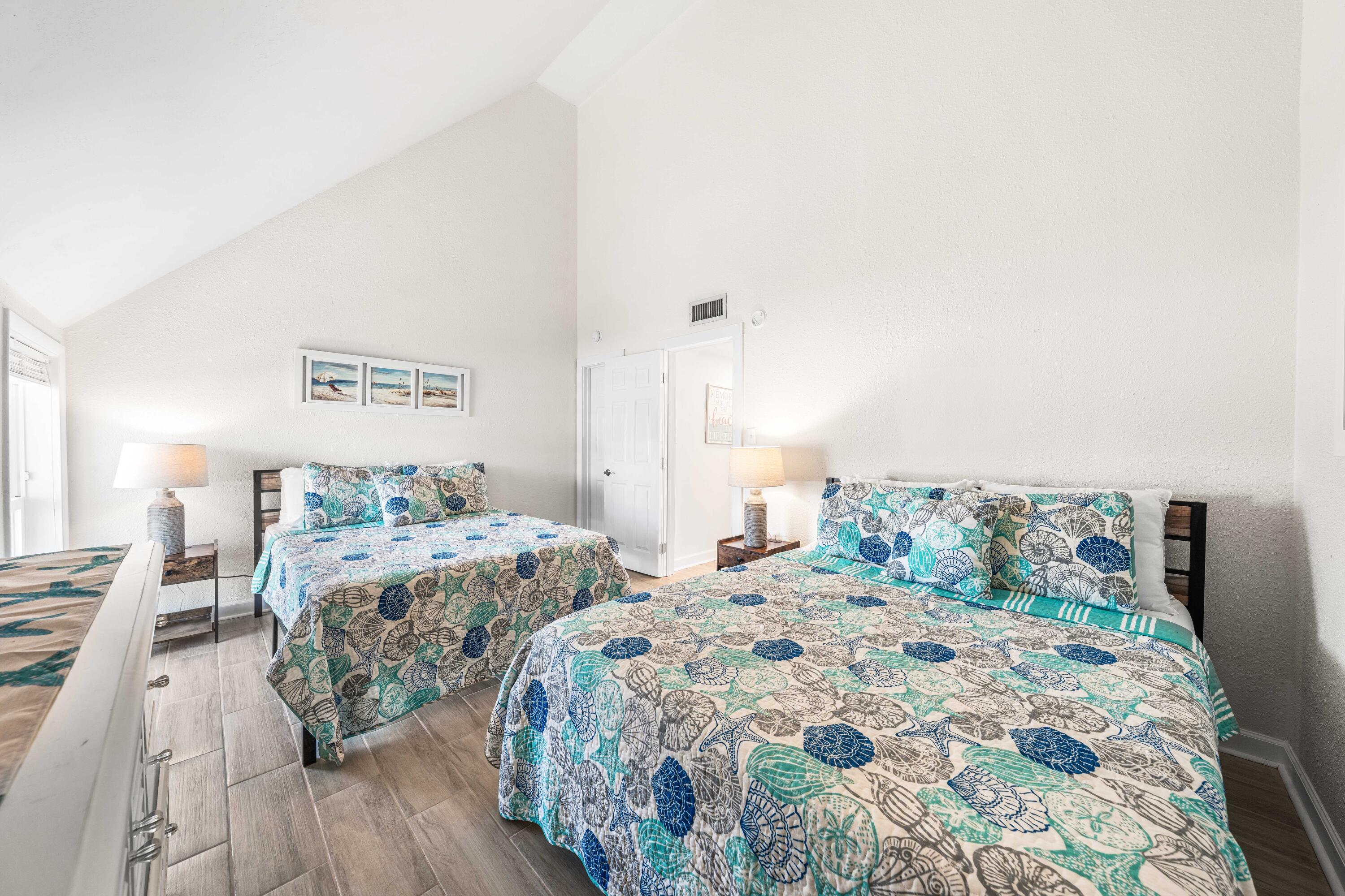 22519 Front Beach Road, Unit 108 Panama City Beach, FL 32413 - Photo 9 of 38 a bedroom with double bed and a lamp