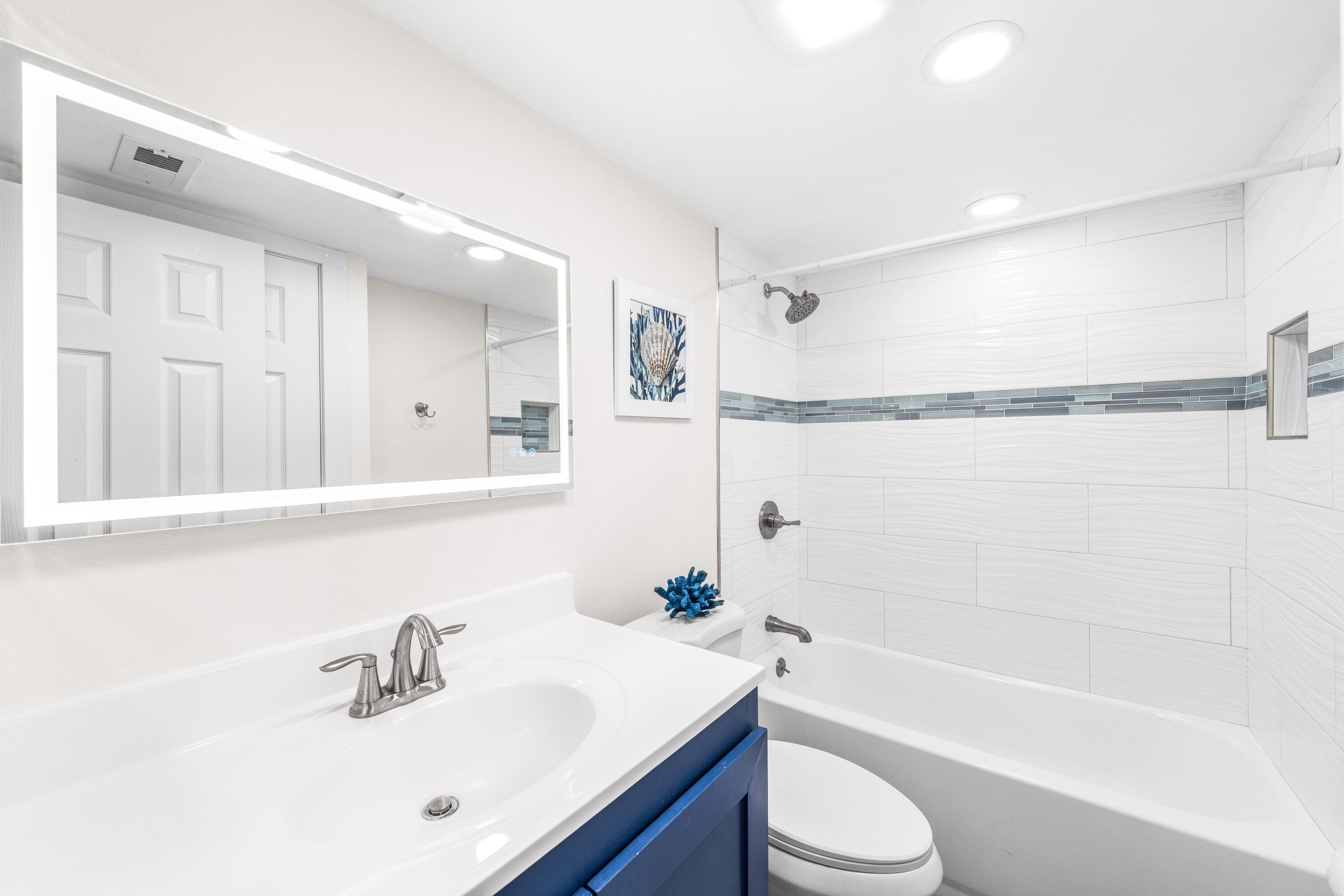 22519 Front Beach Road, Unit 108 Panama City Beach, FL 32413 - Photo 10 of 38 a bathroom with a sink a toilet and a bathtub