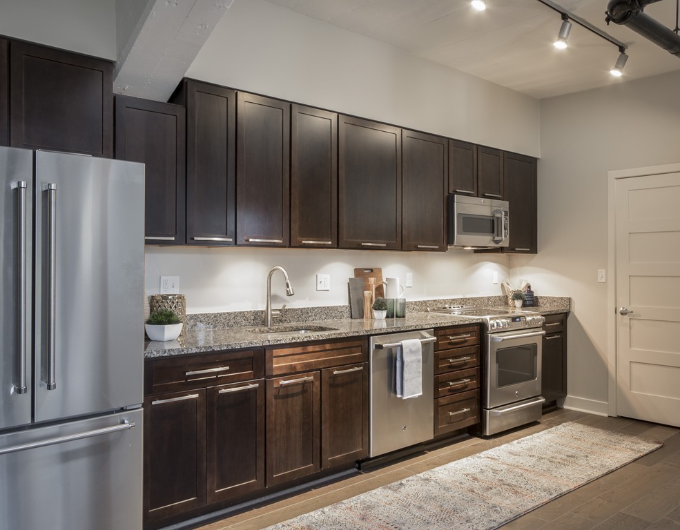 166 Terrace Street, Unit 401 Boston, MA 02120 - Photo 3 of 19 a kitchen with stainless steel appliances granite countertop a stove a refrigerator and a sink