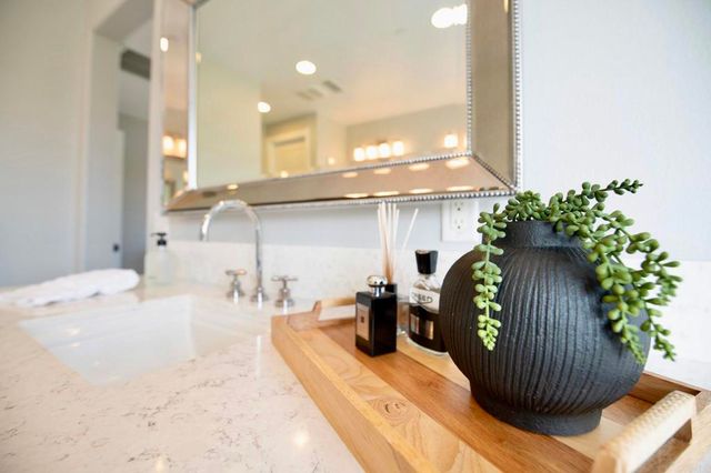 a bedroom with 2 bed and a chandelier