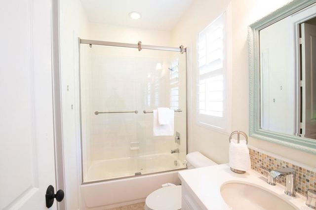 a bedroom with a bed and a mirror