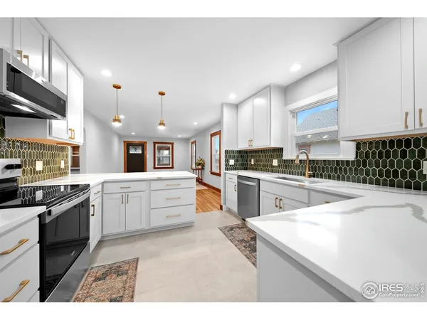 a kitchen with stainless steel appliances kitchen island granite countertop a stove sink and cabinets