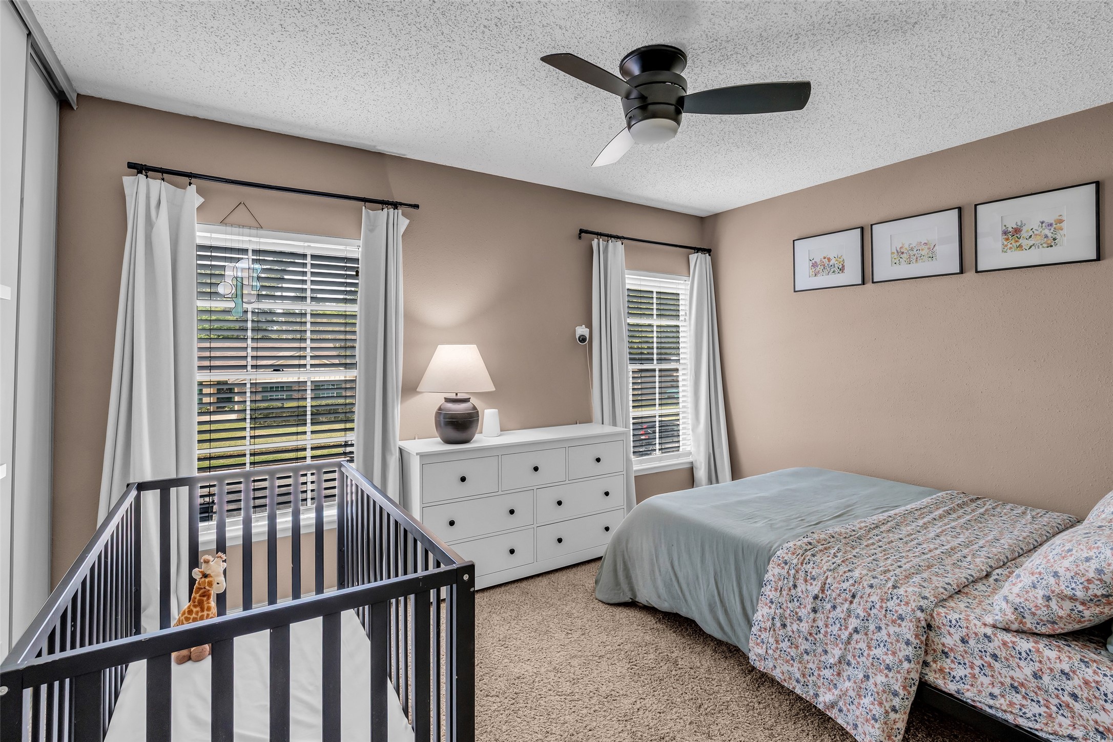 9415 Towerstone Drive Spring, TX 77379 - Photo 33 of 41 Spacious backyard with lush grass, playground set, and patio area, perfect for family activities and relaxation. The two-story home features a brick and siding exterior.