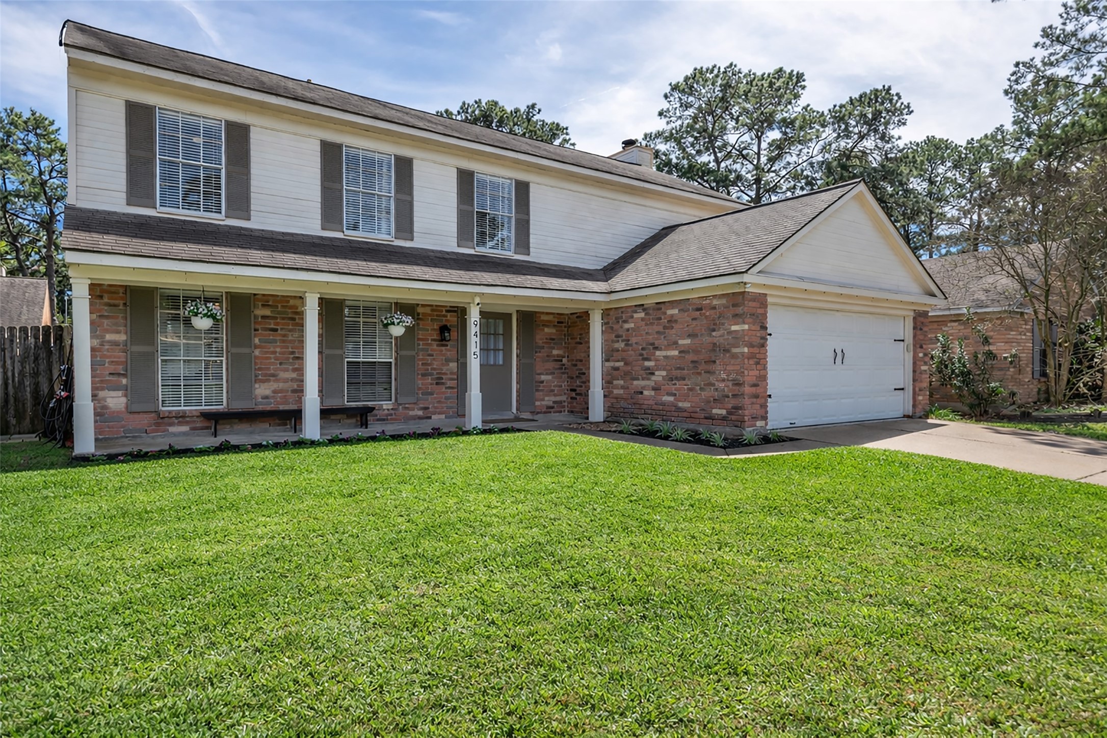 9415 Towerstone Drive Spring, TX 77379 - Photo 6 of 41 This welcoming entryway features a tiled floor leading to carpeted stairs, a white front door with natural light, and a stylish wooden console table with decor and a mirror.