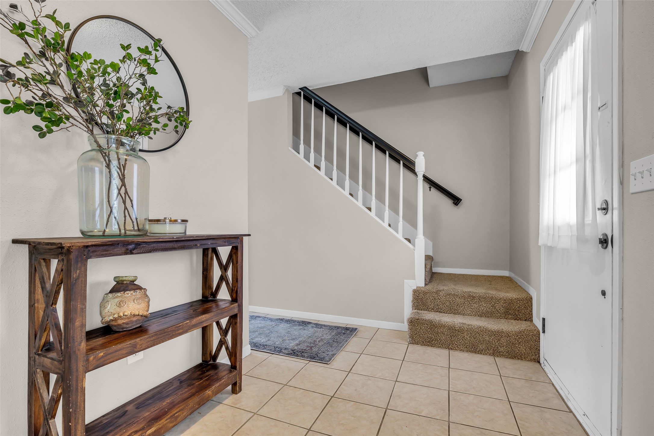 9415 Towerstone Drive Spring, TX 77379 - Photo 9 of 41 This dining room features a large wooden table with six black chairs, a modern light fixture, and ample natural light from two windows with sheer curtains. A potted plant and neutral walls enhance the inviting atmosphere.