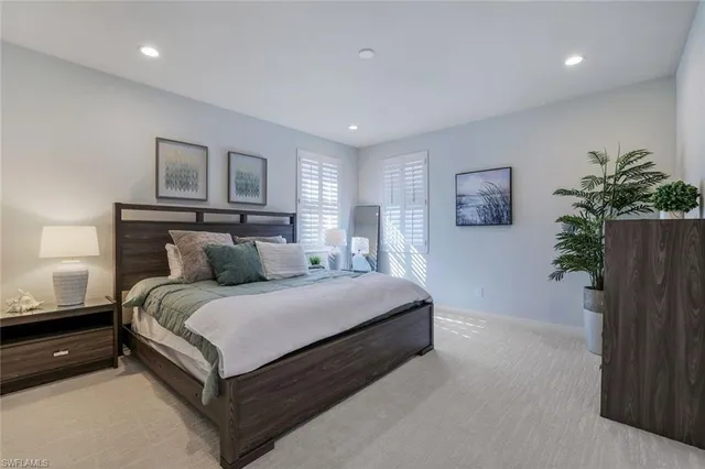 a bed room with a bed and a potted plant