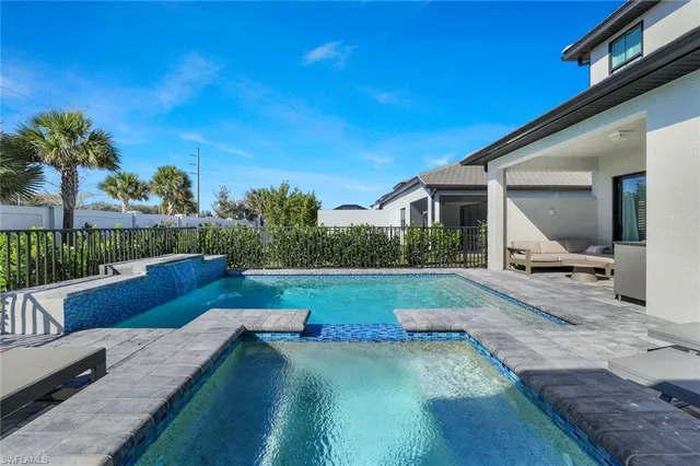 a view of swimming pool with lounge chair