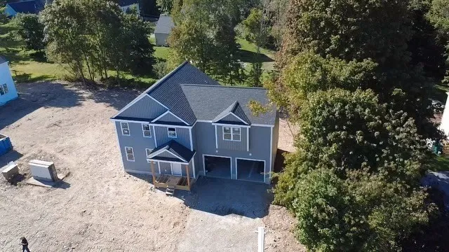 an aerial view of a house with a yard