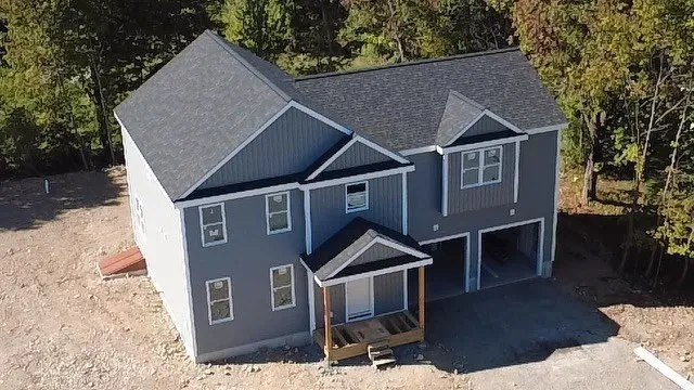 a aerial view of a house with a yard and balcony