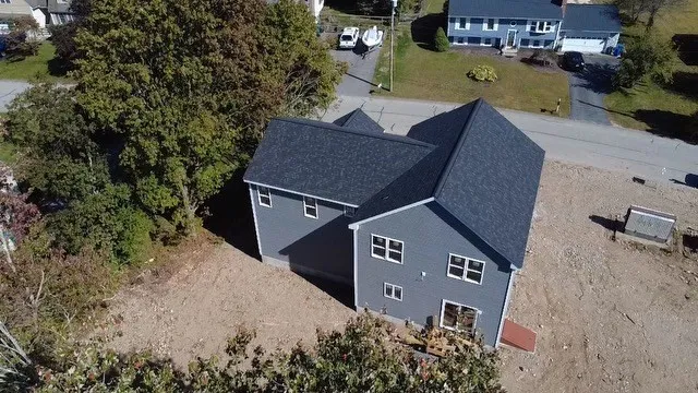 an aerial view of a house with a yard