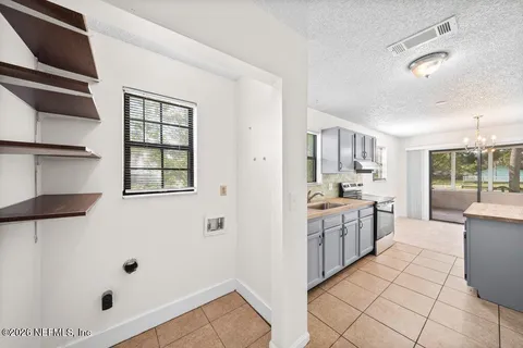 a large white kitchen with cabinets
