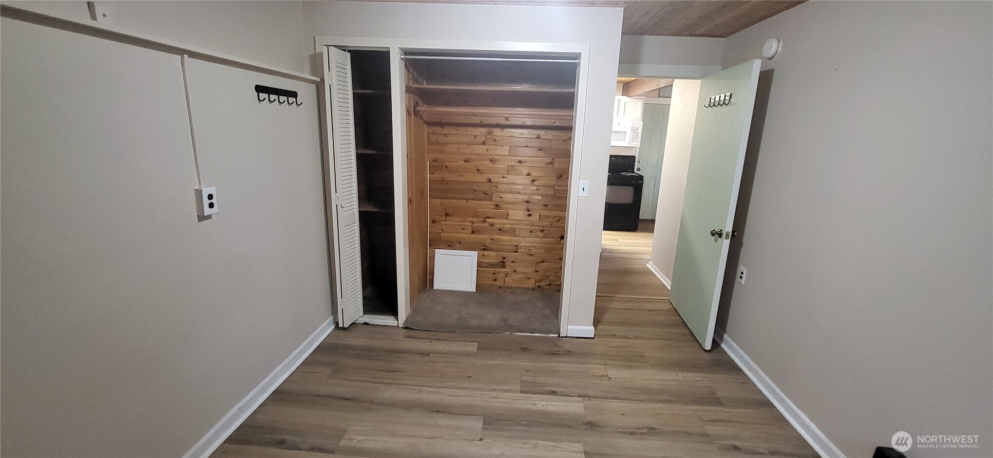 281 North Maple Street, Unit B Camano Island, WA 98282 - Photo 11 of 14 a view of a hallway with wooden floor and entryway