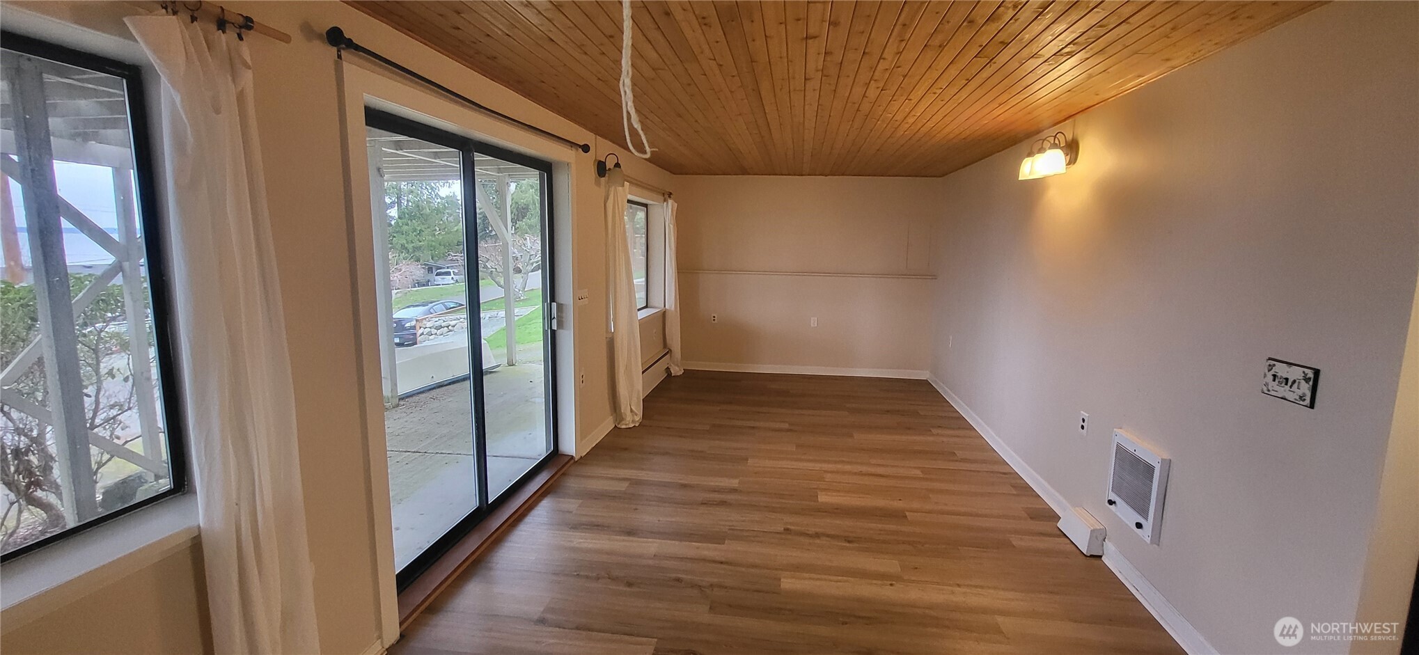 281 North Maple Street, Unit B Camano Island, WA 98282 - Photo 4 of 14 a view of a hallway with wooden floor and staircase