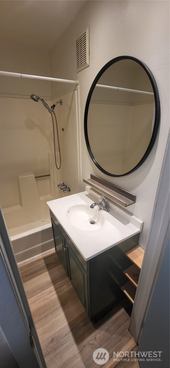 281 North Maple Street, Unit B Camano Island, WA 98282 - Photo 8 of 14 a bathroom with a sink mirror vanity and toilet