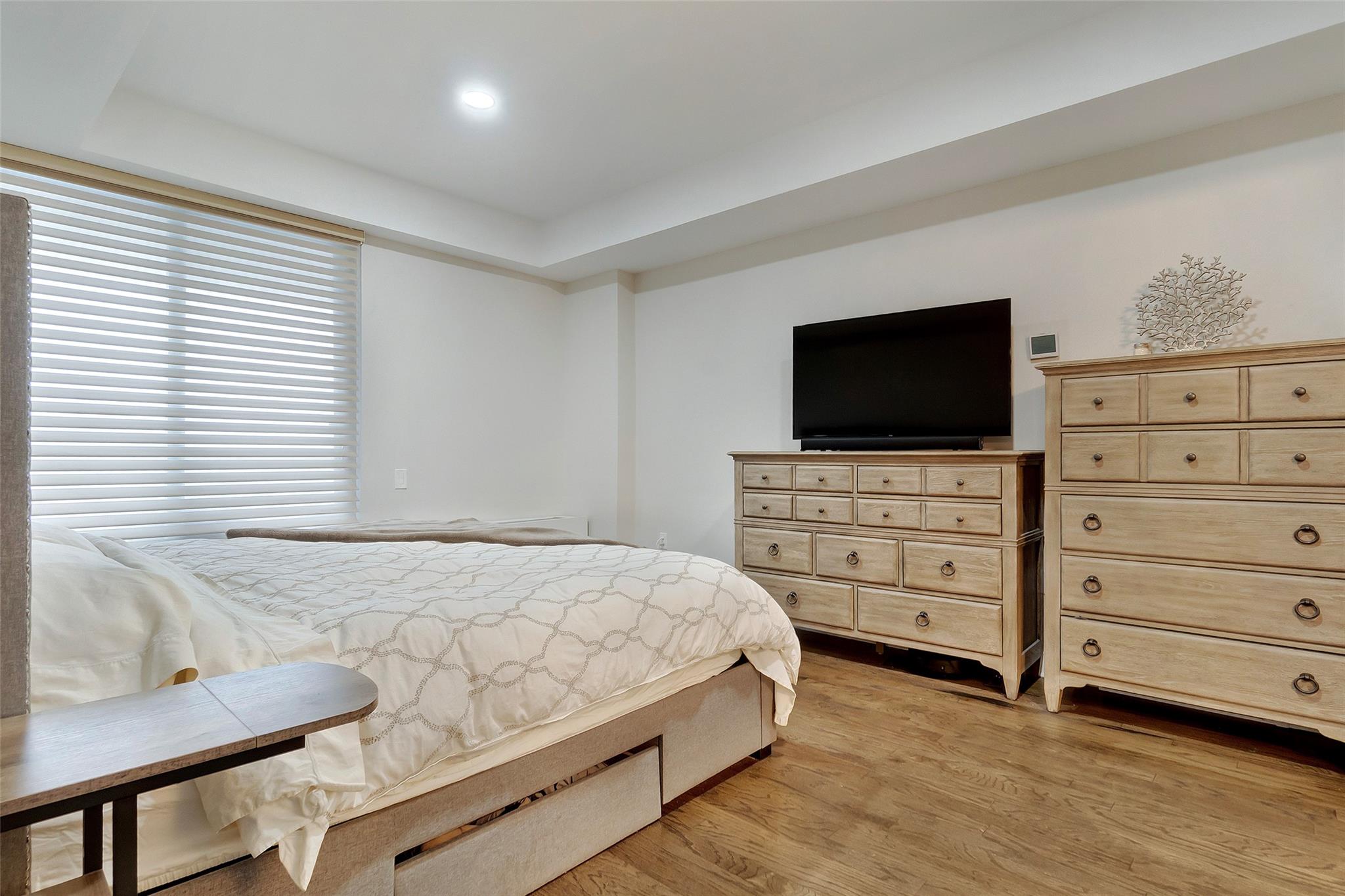 151 Beach 96th Street, Unit 5D Queens, NY 11693 - Photo 11 of 18 Bedroom featuring a raised ceiling and light wood finished floors