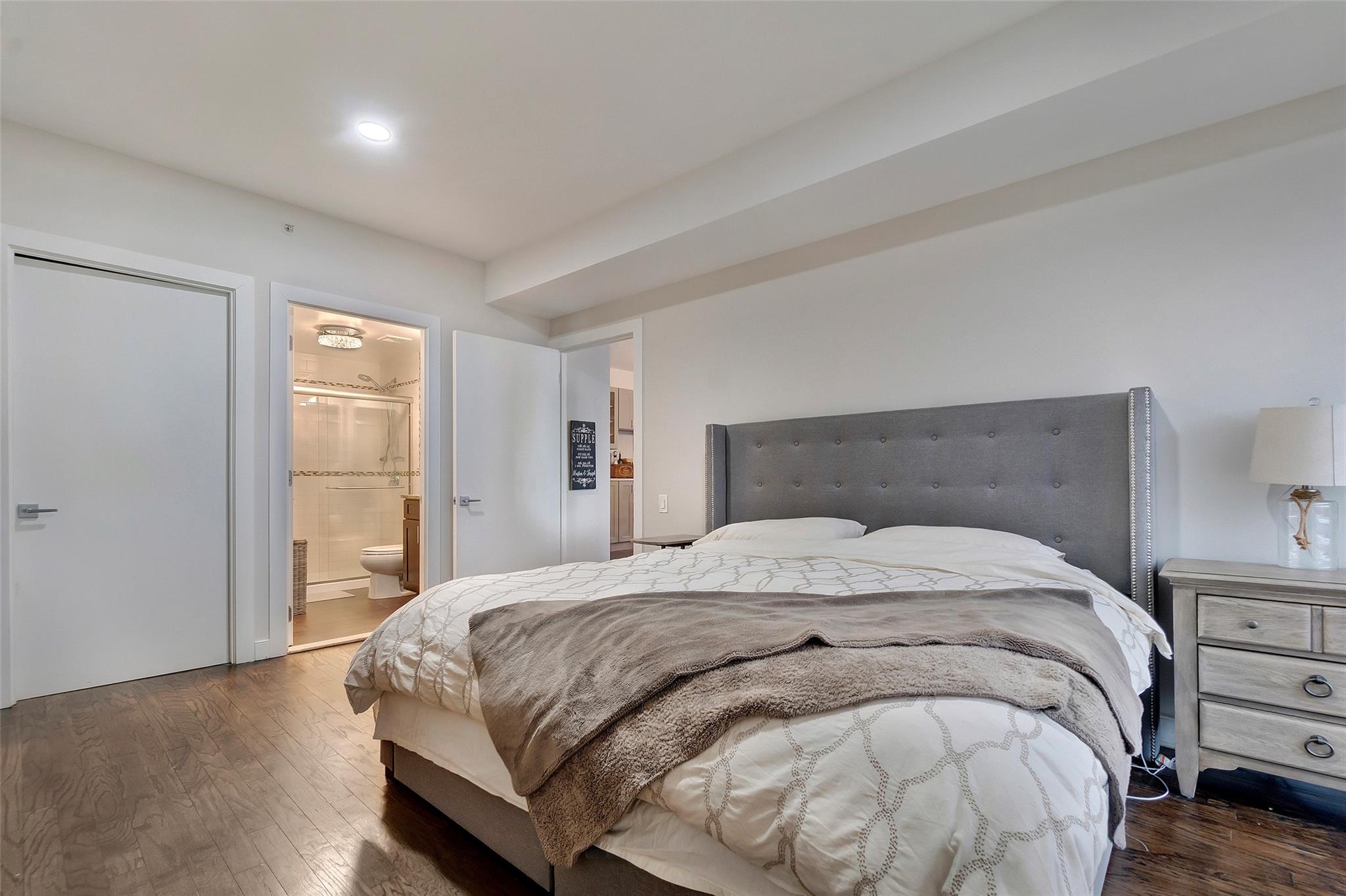 151 Beach 96th Street, Unit 5D Queens, NY 11693 - Photo 13 of 18 Bedroom with dark wood-style flooring and ensuite bath