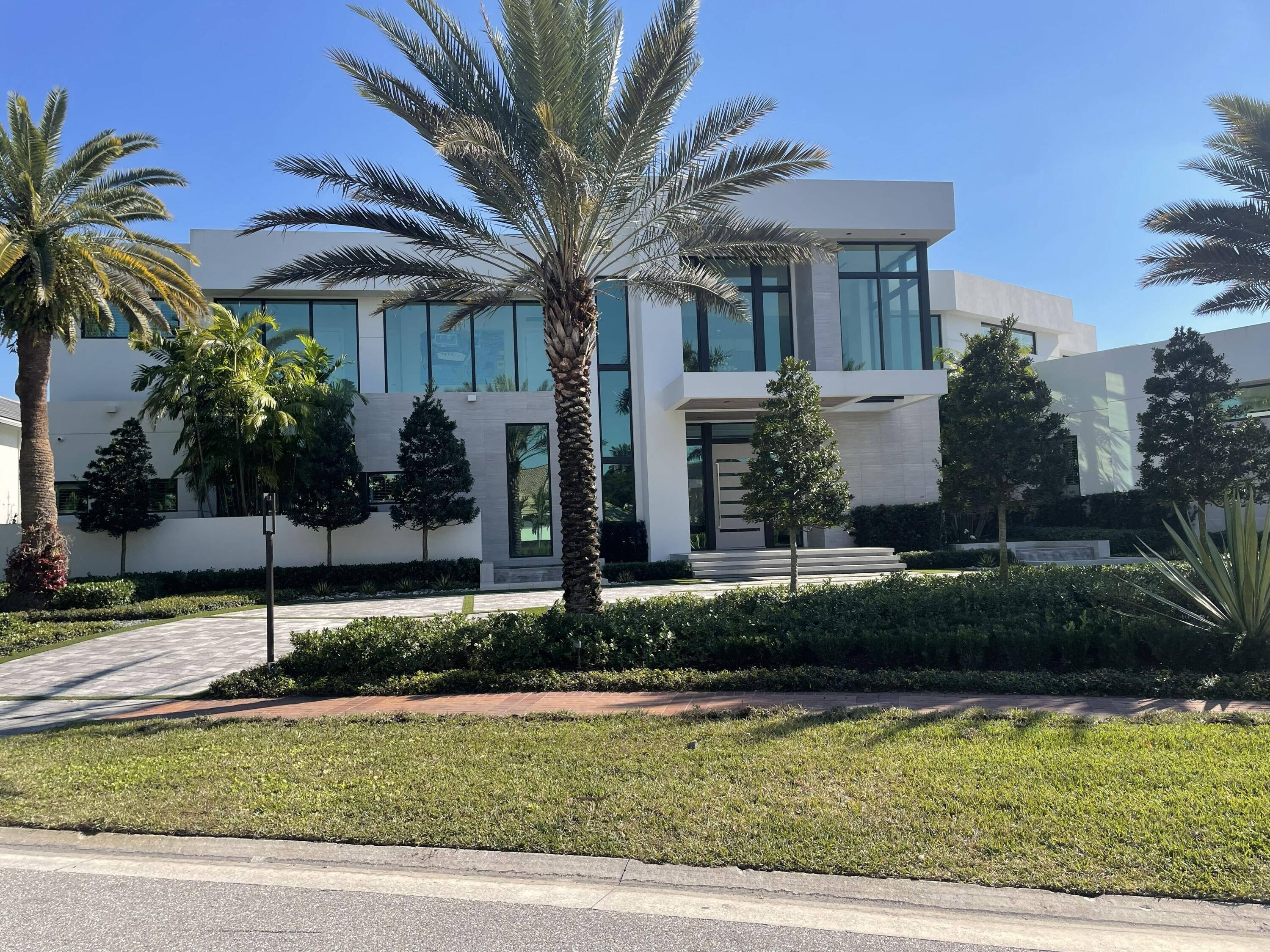 Undisclosed Address Boca Raton, FL 33496 - Photo 1 of 1 a front view of a house with a yard and potted plants