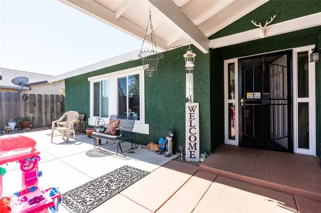 a view of front door with wooden floor and a potted plant