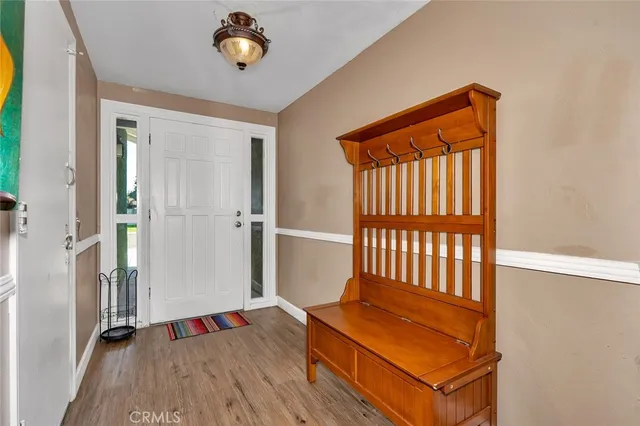 a view of a livingroom with wooden floor and a fireplace