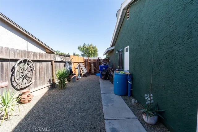 a view of a patio with a table and chairs and potted plants