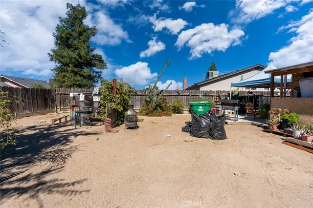 a view of a backyard with table and chairs and potted plants