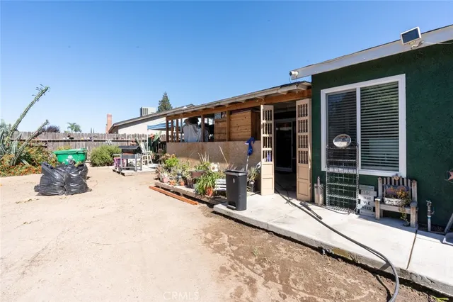 a backyard of a house with outdoor seating