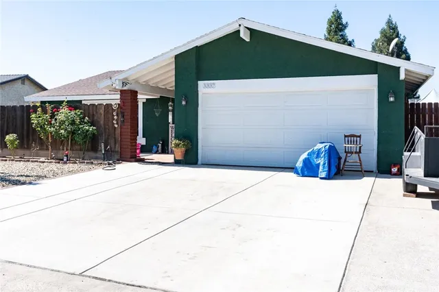 a backyard of a house with barbeque oven and outdoor seating