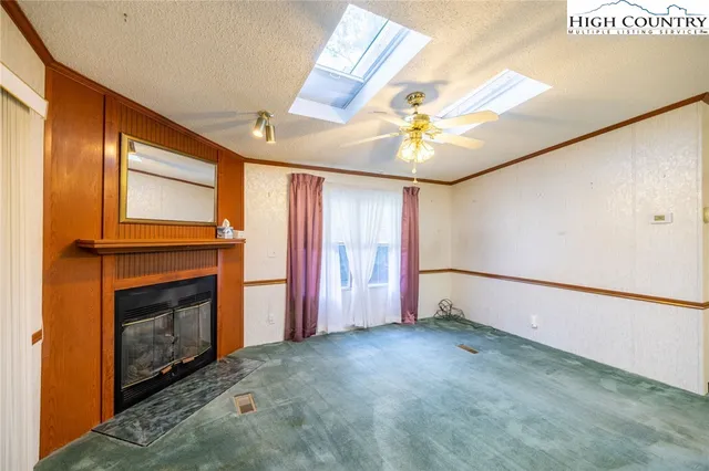 a kitchen that has a refrigerator a stove and a sink with wooden floor