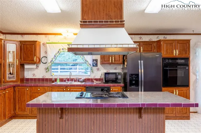 a kitchen with stainless steel appliances granite countertop a stove and a sink
