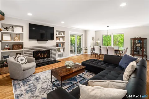 a living room with furniture fireplace and window