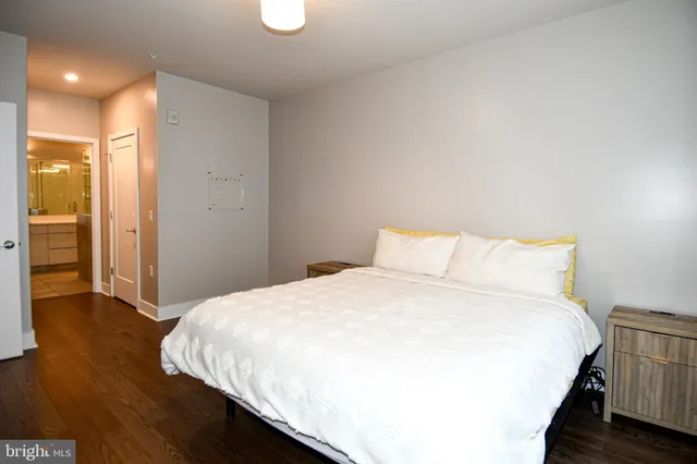 a large bed in a bedroom next to a bathroom