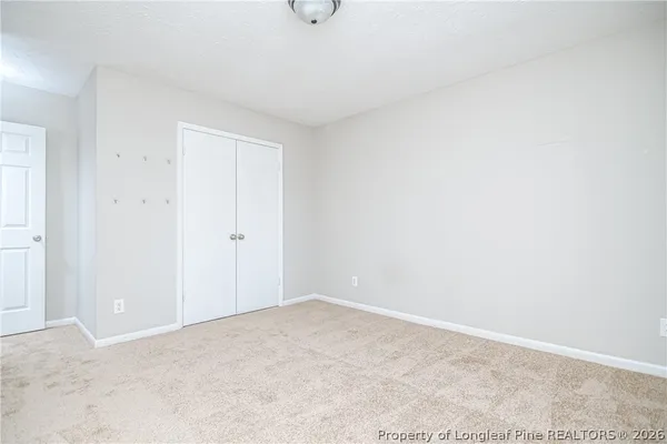 a bedroom with a bed and dresser
