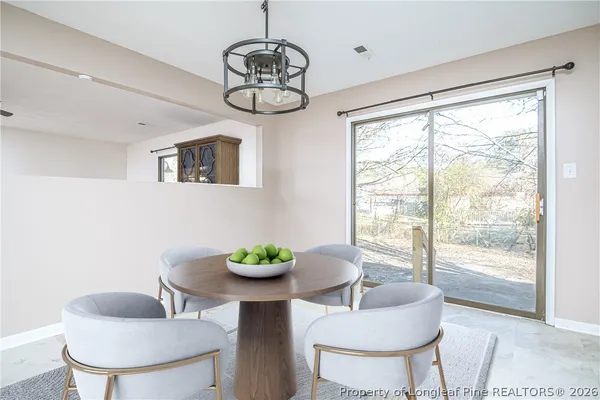 a dining room with furniture a window and a chandelier