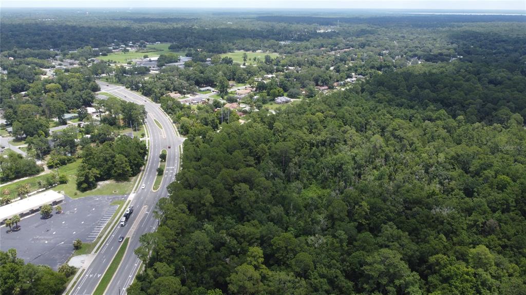 Southeast 22nd Avenue Gainesville, FL 32641 - Photo 5 of 8 an aerial view of a house with a yard and mountain view in back