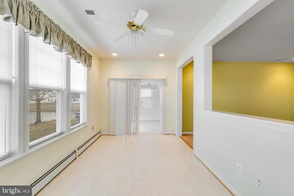 an empty room with a empty space and a ceiling fan