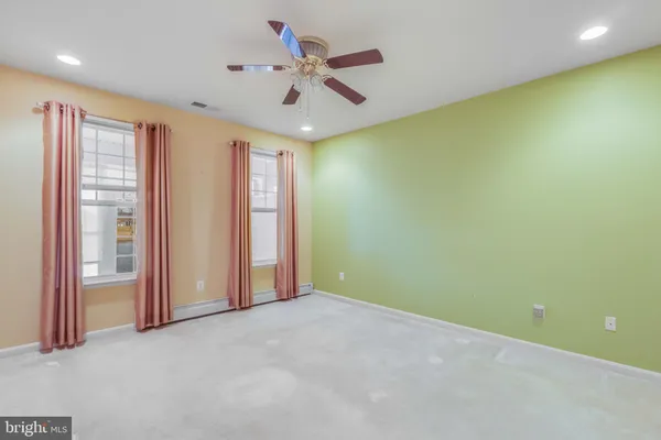 a view of a hallway with wooden floor and glass door