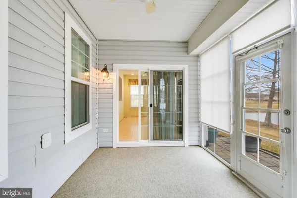 a view of a hallway to rooms and stairs