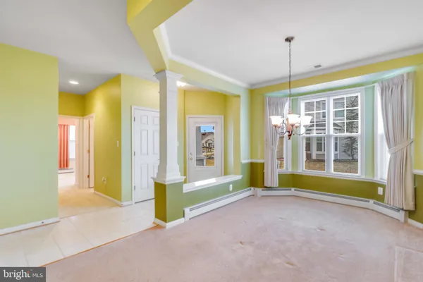 a view of a kitchen with kitchen island a sink windows and a kitchen view
