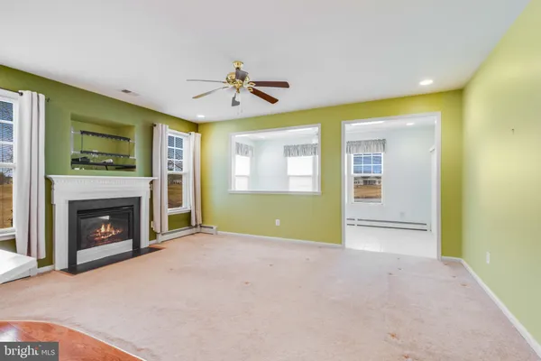 a view of a kitchen with a sink and a fireplace
