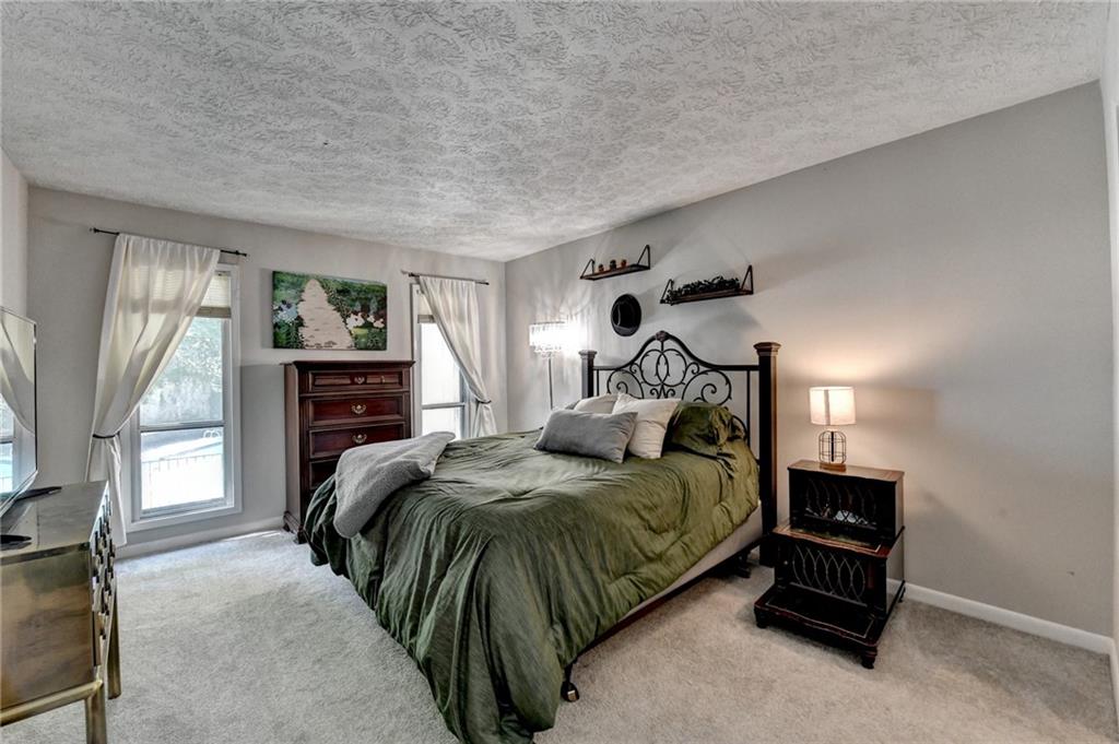 5149 Roswell Road, Unit 7 Atlanta, GA 30342 - Photo 13 of 19 a bedroom with a bed and a tv