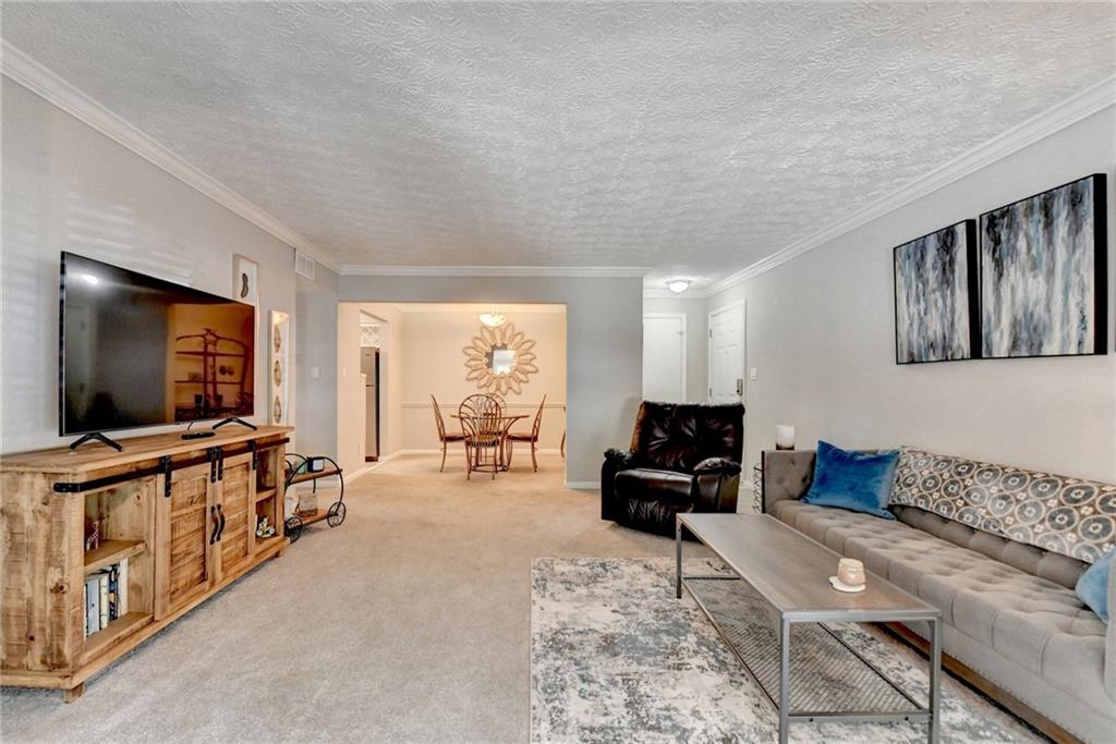 5149 Roswell Road, Unit 7 Atlanta, GA 30342 - Photo 5 of 19 a living room with furniture and a flat screen tv