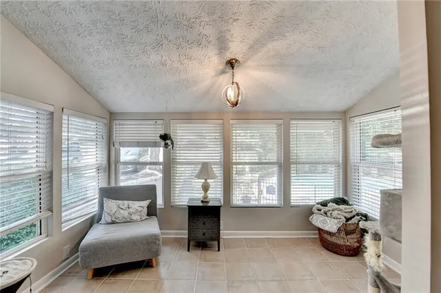 a bedroom with furniture and large windows