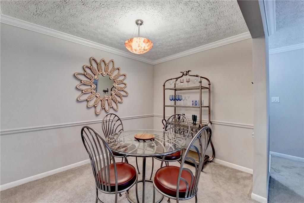 5149 Roswell Road, Unit 7 Atlanta, GA 30342 - Photo 8 of 19 a view of a dining room with furniture and chandelier