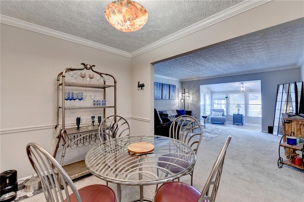 5149 Roswell Road, Unit 7 Atlanta, GA 30342 - Photo 9 of 19 a dining room with furniture a chandelier and window