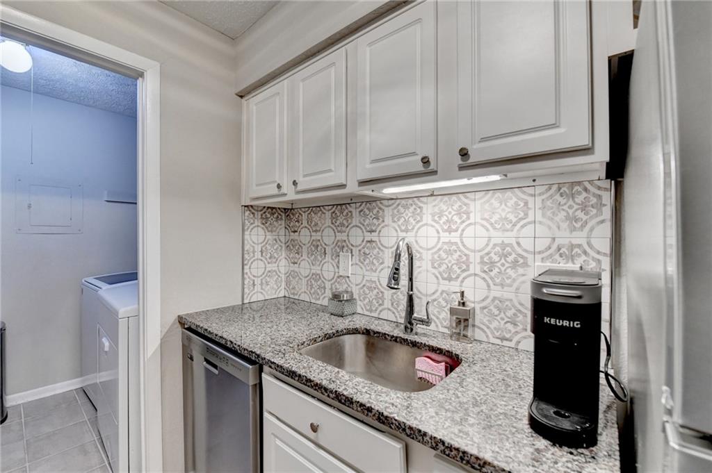 5149 Roswell Road, Unit 7 Atlanta, GA 30342 - Photo 10 of 19 a kitchen with granite countertop a sink stove and cabinets