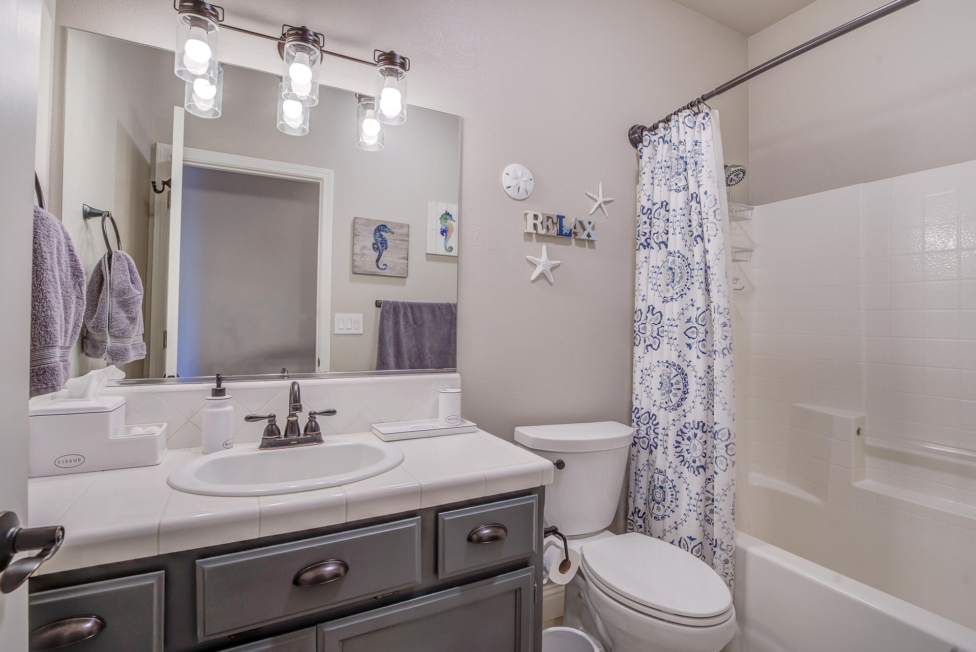 4090 Cambria Drive Redding, CA 96002 - Photo 23 of 48 a bathroom with a sink toilet a mirror a vanity and shower