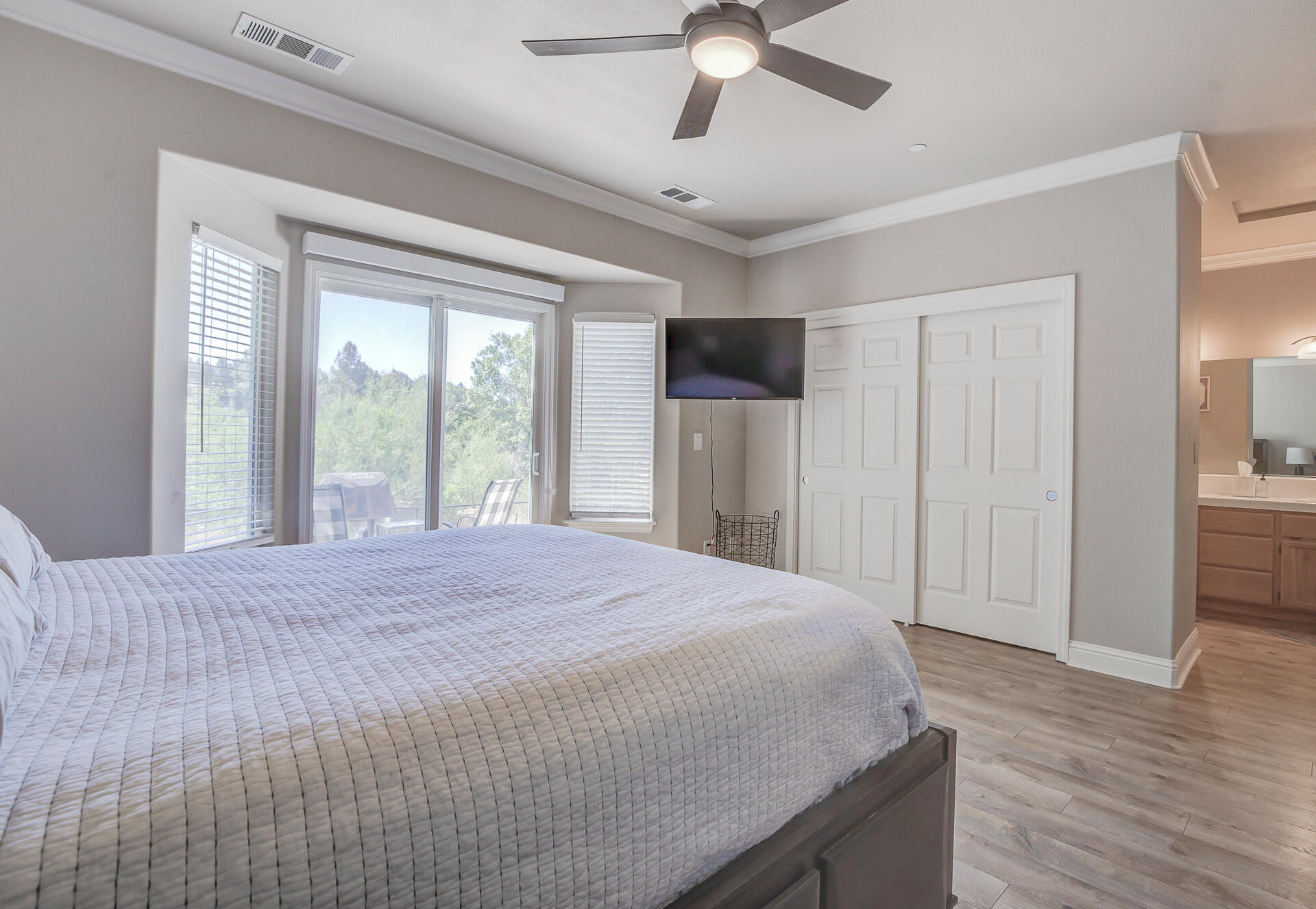 4090 Cambria Drive Redding, CA 96002 - Photo 33 of 48 a spacious bedroom with a bed and a chandelier