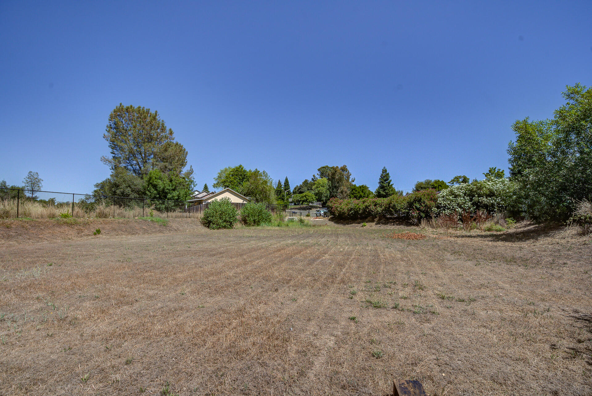 4090 Cambria Drive Redding, CA 96002 - Photo 46 of 48 a view of a large space with a lake in the background