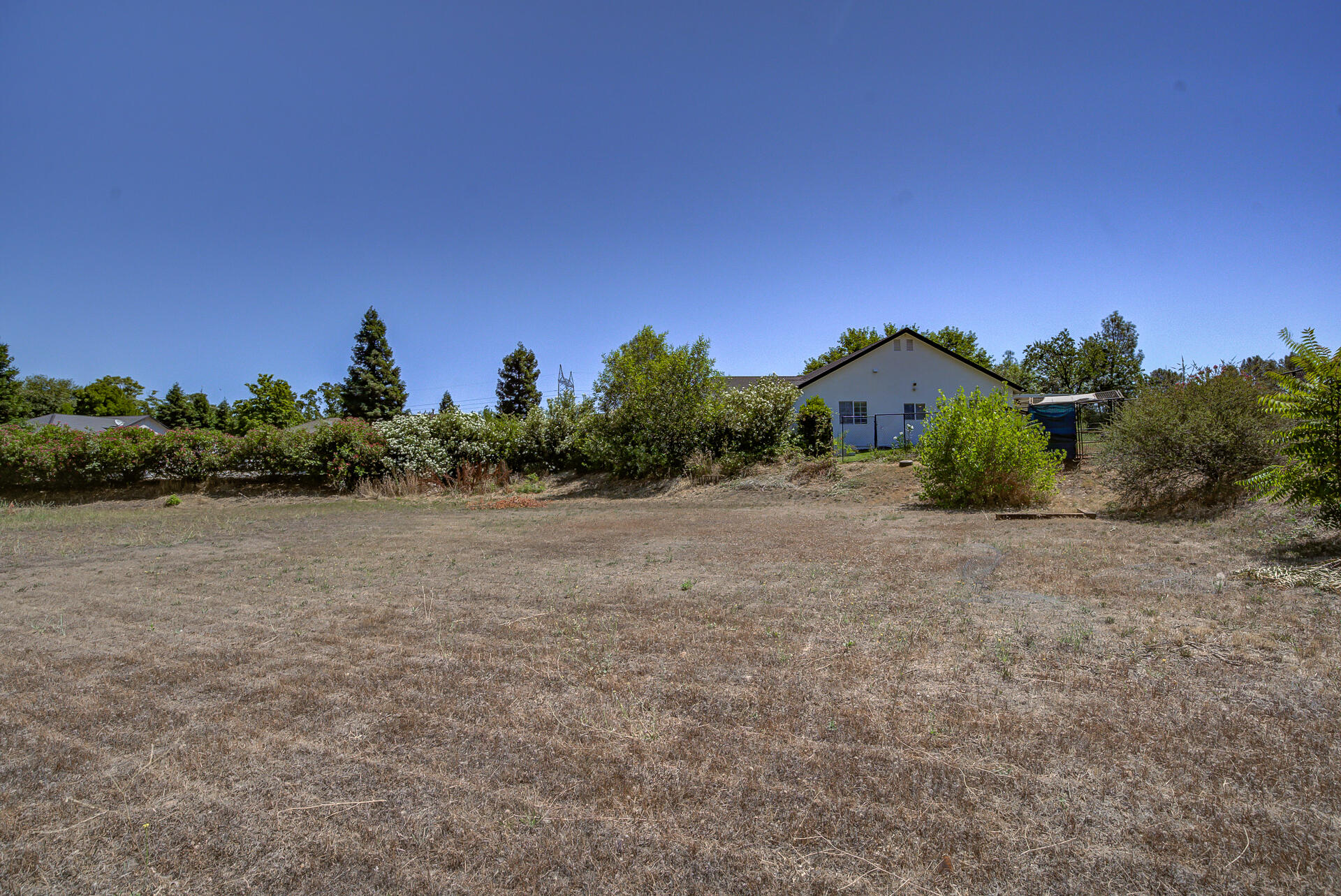 4090 Cambria Drive Redding, CA 96002 - Photo 47 of 48 a view of a dry yard with wooden fence