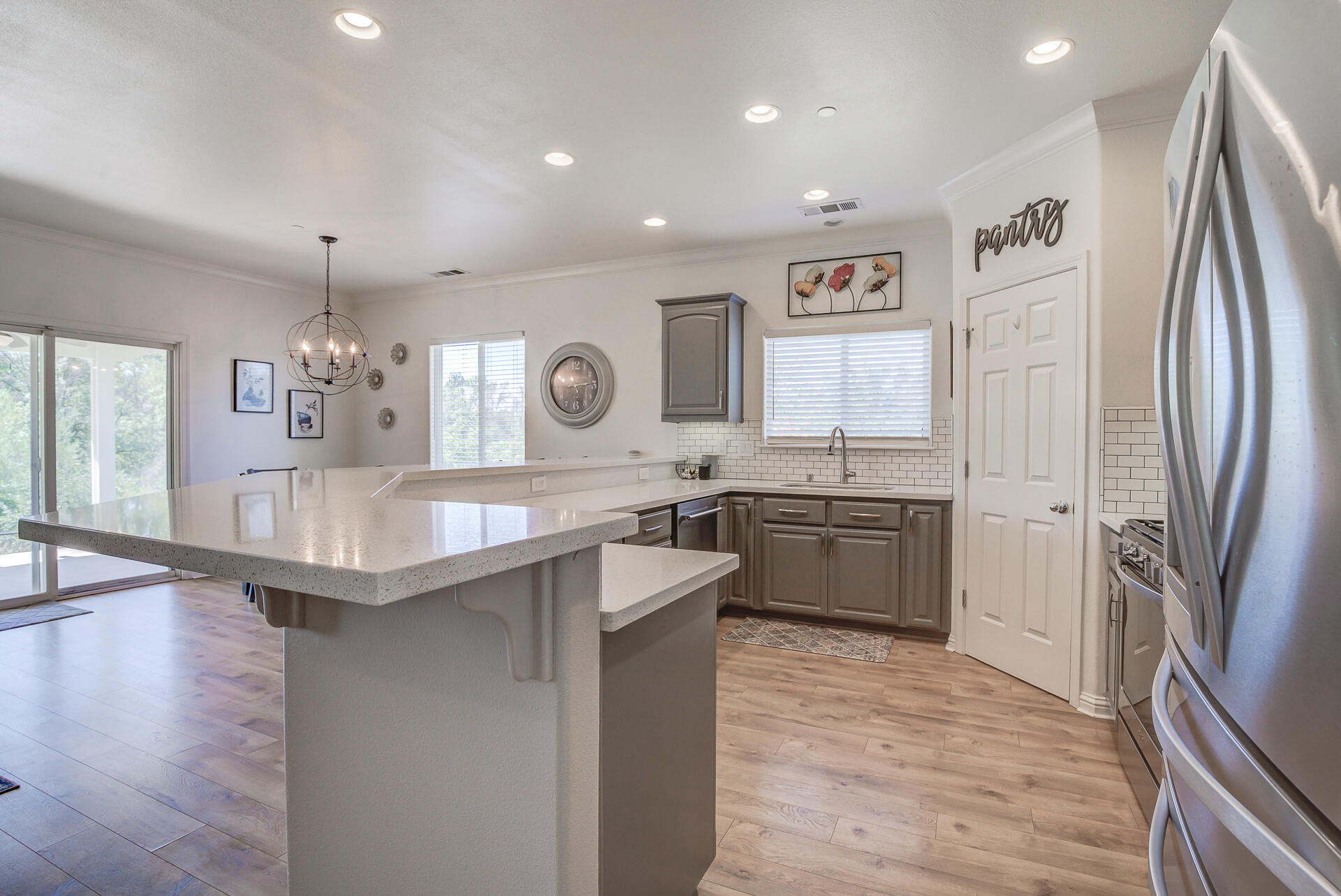 4090 Cambria Drive Redding, CA 96002 - Photo 9 of 48 a kitchen with stainless steel appliances granite countertop a refrigerator a sink dishwasher a stove and white countertops with wooden floor